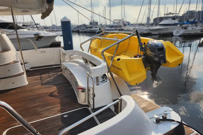 Slide: The Image of 2013 Fountaine Pujut Summerland 40 yacht with yellow dinghy and Yamaha motor at marina. - 4
