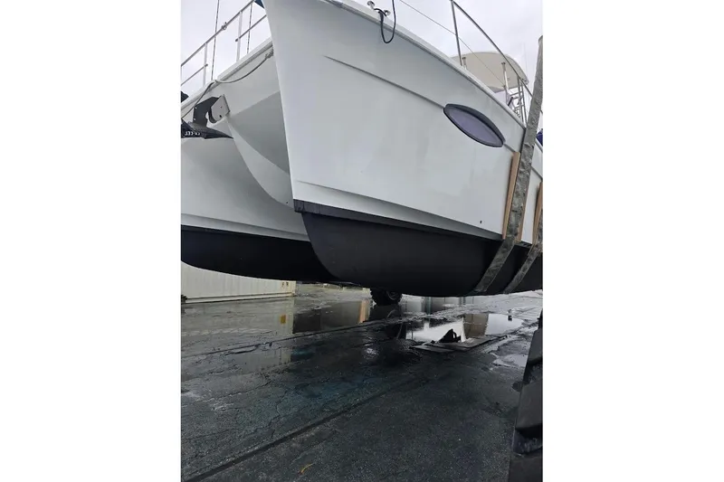 Slide: The Image of 2013 Fountaine Pajot Summerland 40 catamaran on a wet dock, side view. - 43