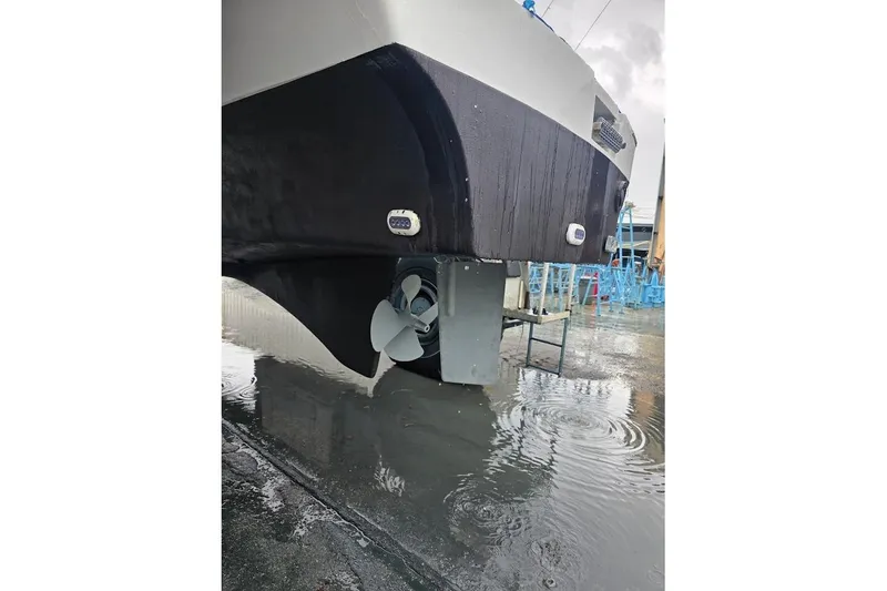 Slide: The Image of 2013 Fountaine Pajot Summerland 40 catamaran hull and propeller in a wet dockyard. - 44