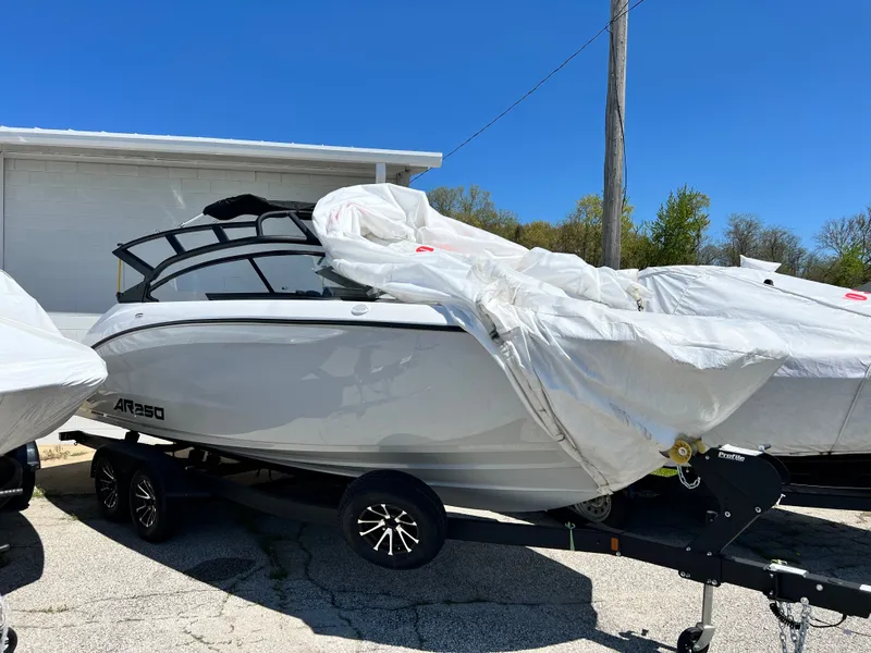 Slide: The Image of 2025 Yamaha AR250 boat on trailer, partially covered. - 10