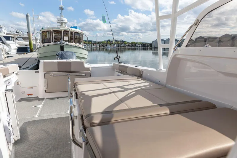 Slide: The Image of Luxurious 2026 Solara S-250 DC boat interior with comfortable seating, docked at a marina. - 19