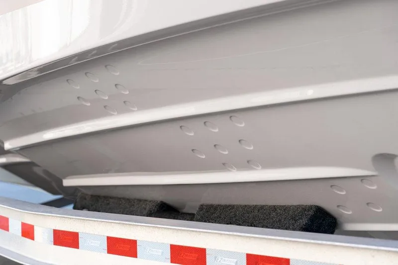 Slide: The Image of 2026 Solara S-250 DC boat hull on trailer, showcasing sleek design and craftsmanship. - 21