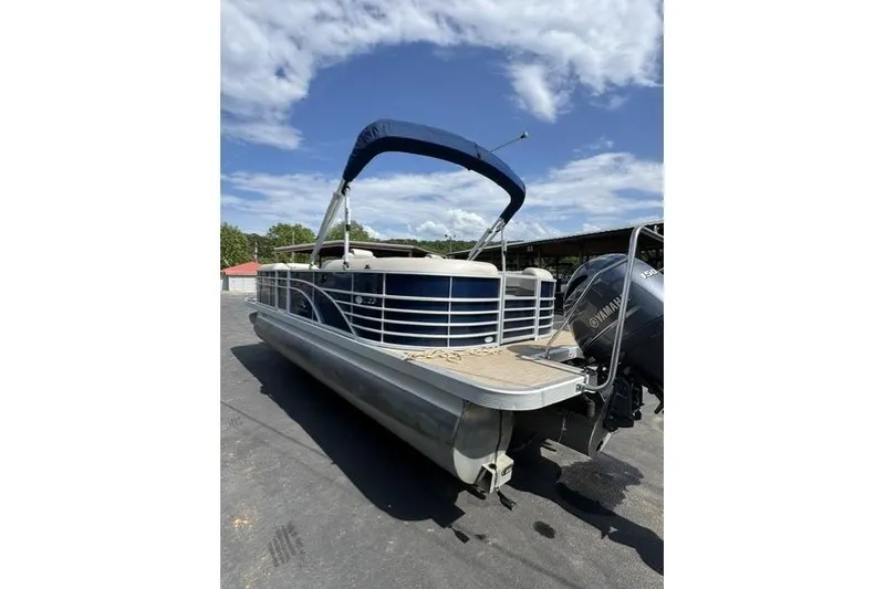 Slide: The Image of 2018 Bennington 22 GSR pontoon boat with Yamaha outboard motor, parked outdoors. - 1