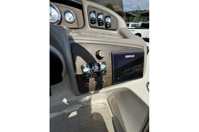 Slide: The Image of 2018 Bennington 22 GSR boat dashboard with Simrad display and control switches. - 3