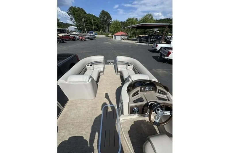 Slide: The Image of 2018 Bennington 22 GSR pontoon boat interior with beige seating and steering console. - 5