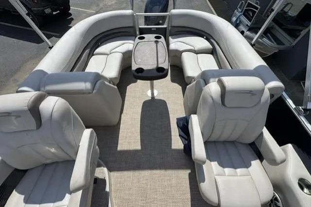 Slide: The Image of 2018 Bennington 22 GSR pontoon boat interior with plush seating and central table. - 8