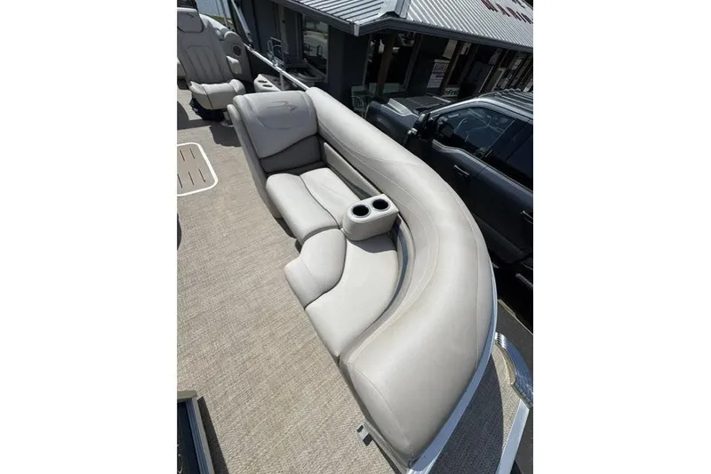 Slide: The Image of 2018 Bennington 22 GSR boat interior with beige seating and cup holders. - 9