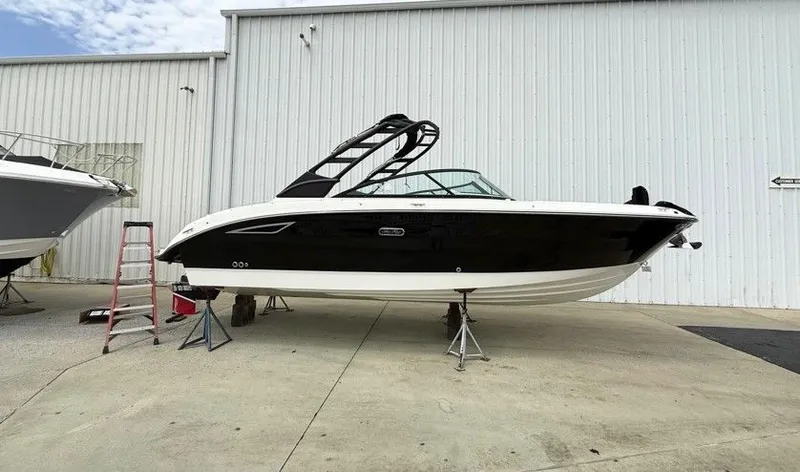 The Image of 2025 Sea Ray SDX 270 boat on stands outside warehouse. - 0