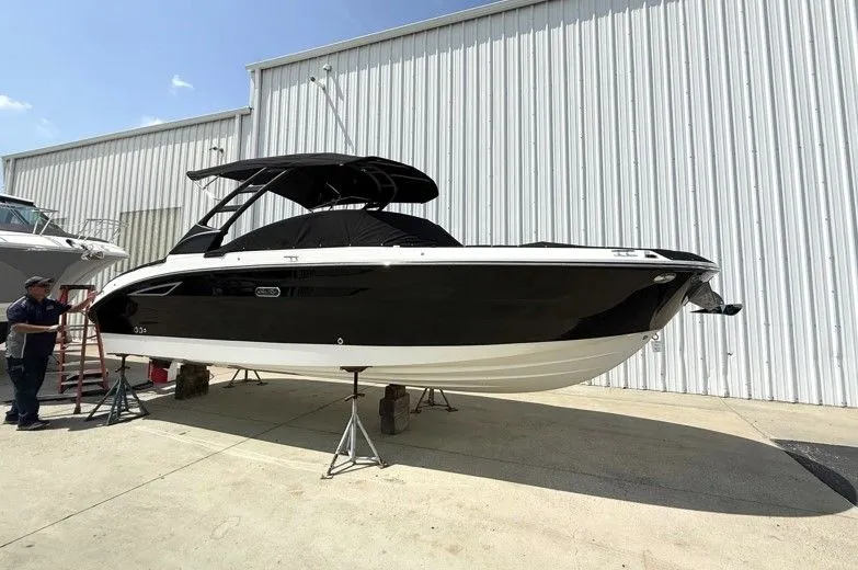 Slide: The Image of 2025 Sea Ray SDX 270 boat on stands outside warehouse. - 6