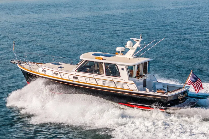 The Image of 2008 Grand Banks 45 Eastbay SX cruising on open water with American flag. - 0