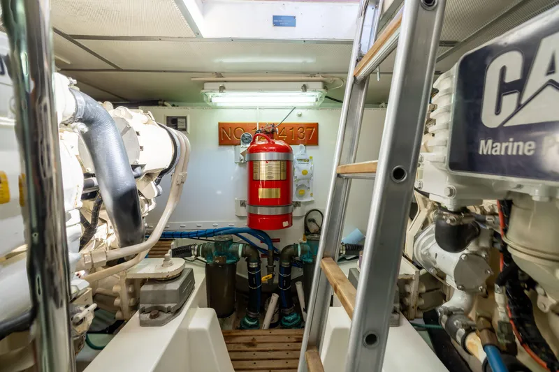 Slide: The Image of Engine room of 2008 Grand Banks 45 Eastbay SX with fire extinguisher and marine equipment. - 23
