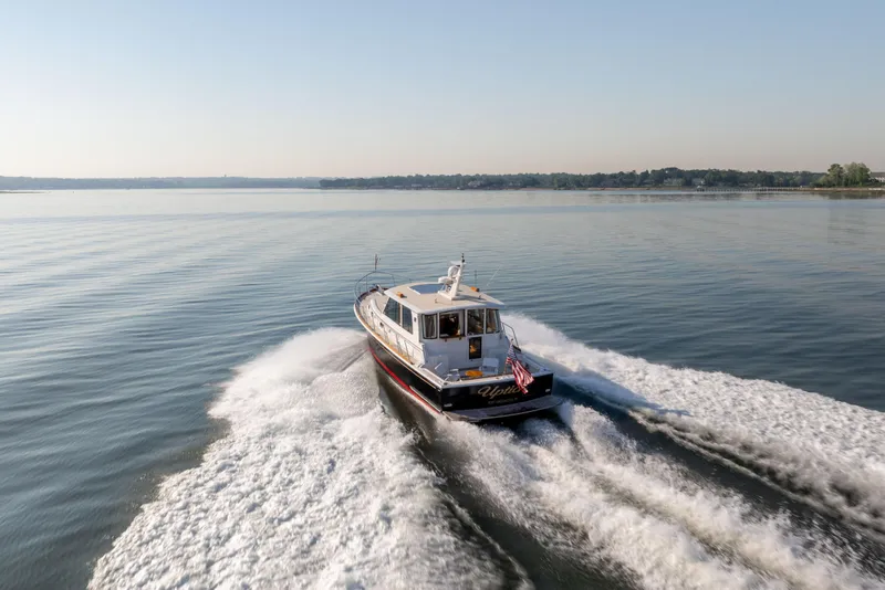 Slide: The Image of 2008 Grand Banks 45 Eastbay SX cruising on calm waters under clear skies. - 26