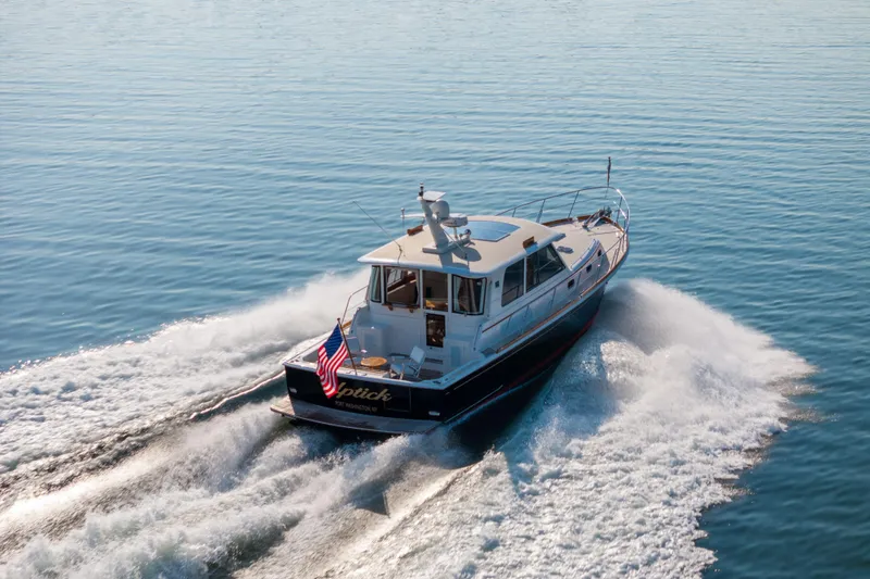 Slide: The Image of 2008 Grand Banks 45 Eastbay SX cruising on calm blue waters, rear view. - 28