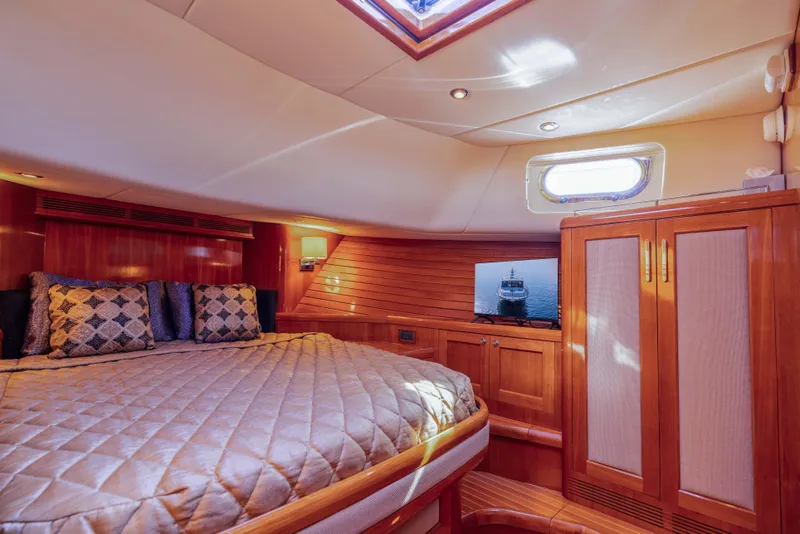 Slide: The Image of Luxurious 2008 Grand Banks 45 Eastbay SX yacht cabin with elegant wood finishes and cozy bedding. - 4