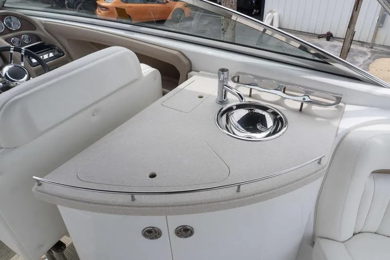 Slide: The Image of Interior of a 2007 Cobalt 323 boat featuring a sleek sink and countertop area. - 10