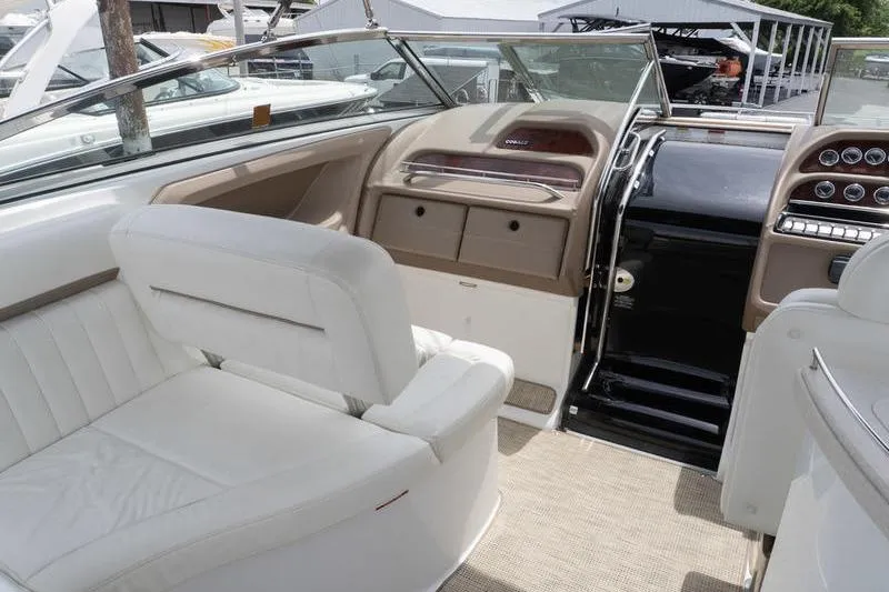 Slide: The Image of Interior of a 2007 Cobalt 323 boat with white seating and control panel. - 11