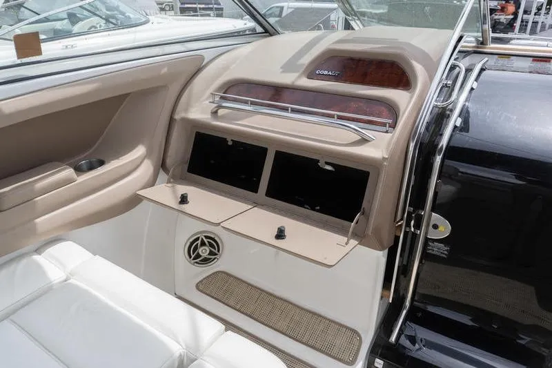 Slide: The Image of Interior of a 2007 Cobalt 323 boat with open storage compartments. - 12