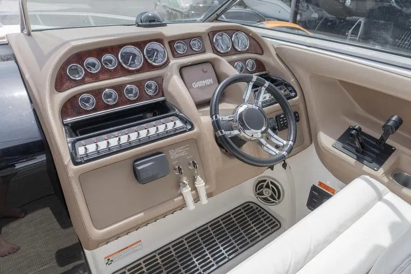 Slide: The Image of 2007 Cobalt 323 boat dashboard with Garmin navigation, steering wheel, and control panel. - 13