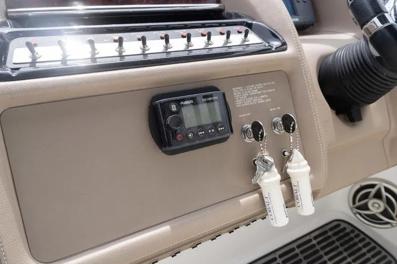Slide: The Image of Dashboard of a 2007 Cobalt 323 boat featuring control panel and ignition keys. - 15