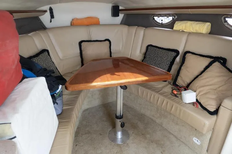 Slide: The Image of Interior of a 2007 Cobalt 323 boat with beige seating and wooden table. - 17