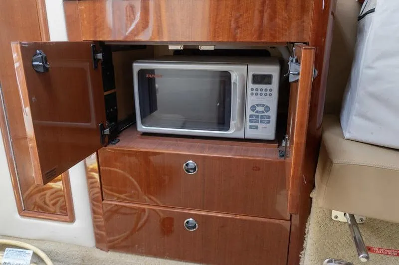 Slide: The Image of Built-in microwave in a 2007 Cobalt 323 boat's wooden cabinet. - 20