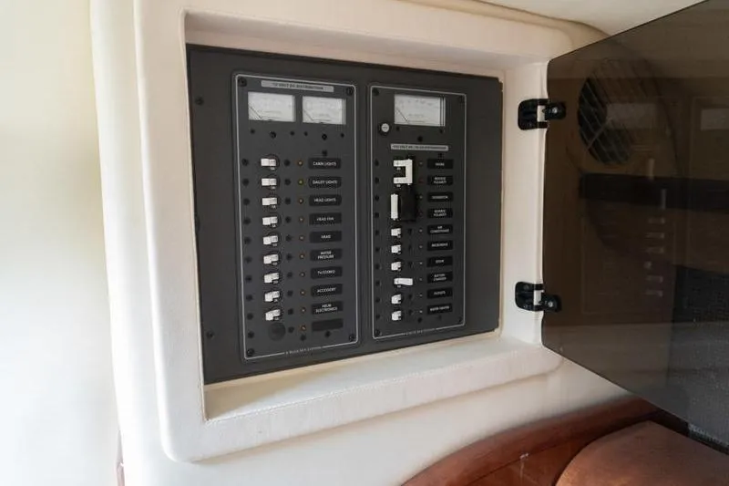 Slide: The Image of Electrical control panel inside a 2007 Cobalt 323 boat, featuring switches and meters. - 22