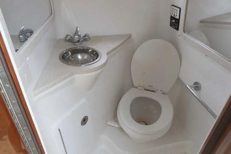 Slide: The Image of Compact bathroom in a 2007 Cobalt 323 boat with sink and toilet. - 24