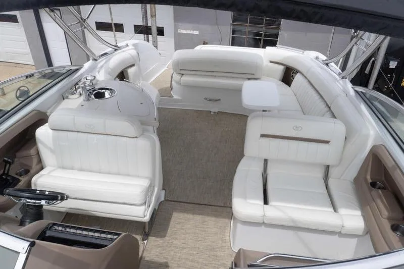 Slide: The Image of Interior of a 2007 Cobalt 323 boat with white seating and modern amenities. - 28
