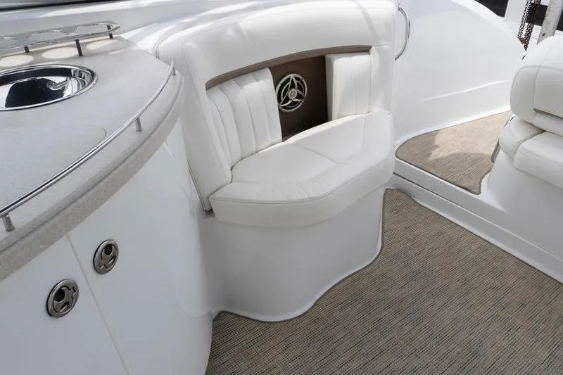 Slide: The Image of Luxurious interior of a 2007 Cobalt 323 boat with white seating and carpeted flooring. - 30