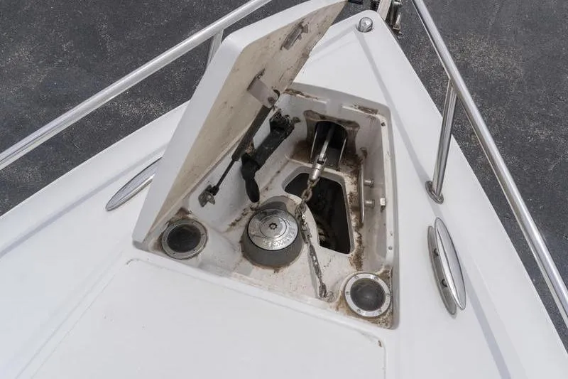 Slide: The Image of Anchor compartment of a 2007 Cobalt 323 boat, featuring chain and winch. - 34