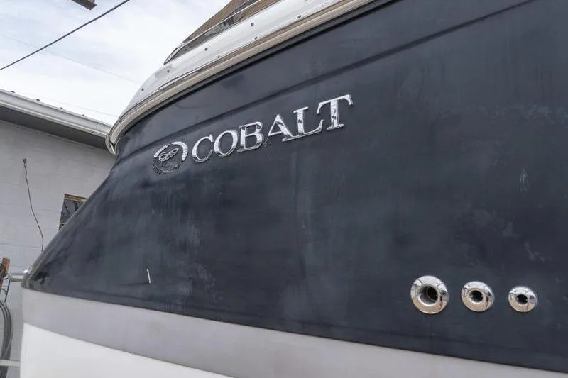 Slide: The Image of 2007 Cobalt 323 boat with logo and chrome details on the hull. - 36