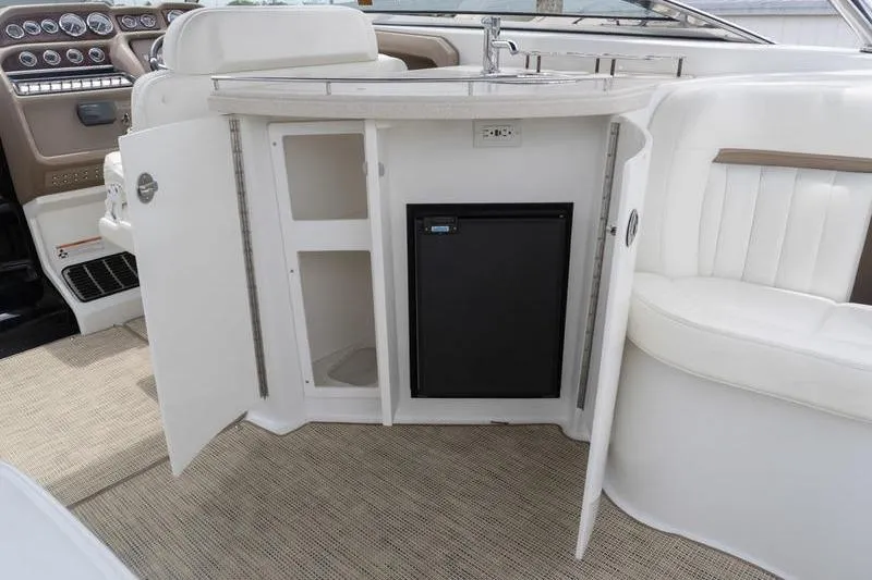 Slide: The Image of 2007 Cobalt 323 boat interior with open cabinets and mini fridge. - 9