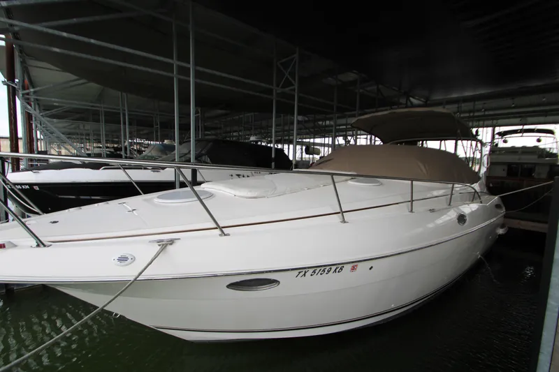 The Image of 2003 Cruisers Yachts 320 Express docked in a covered marina. - 0