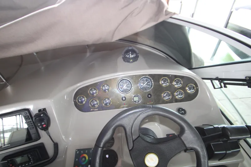 Slide: The Image of Dashboard of a 2003 Cruisers Yachts 320 Express with gauges and steering wheel. - 13