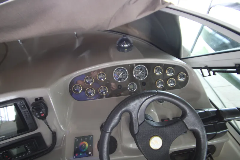 Slide: The Image of 2003 Cruisers Yachts 320 Express helm with gauges and steering wheel. - 14