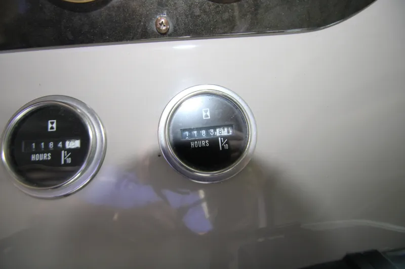 Slide: The Image of Hour meters on a 2003 Cruisers Yachts 320 Express dashboard, displaying engine hours. - 16