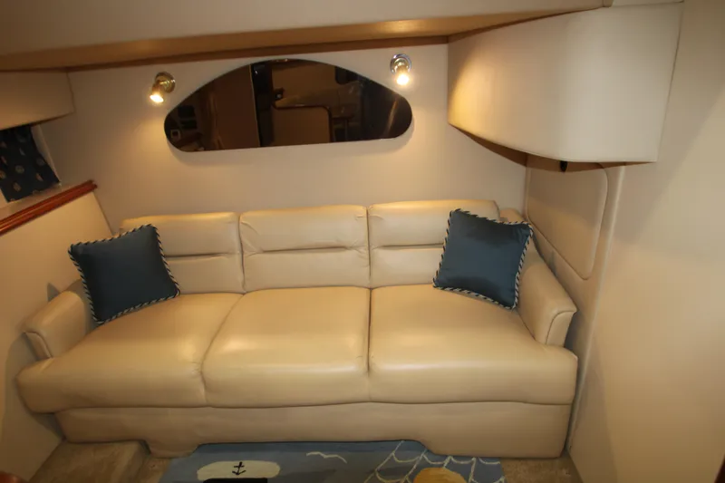 Slide: The Image of Luxurious interior of 2003 Cruisers Yachts 320 Express with beige leather sofa and blue cushions. - 17