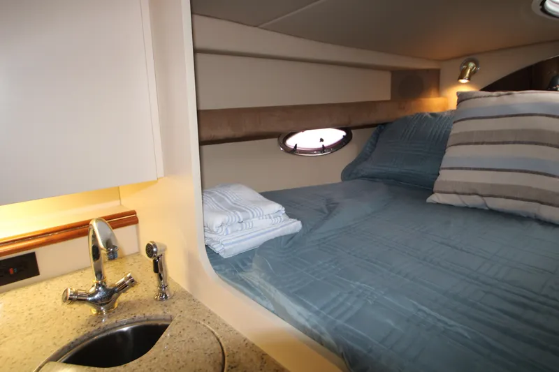 Slide: The Image of Cozy cabin interior of 2003 Cruisers Yachts 320 Express with bed and sink. - 20