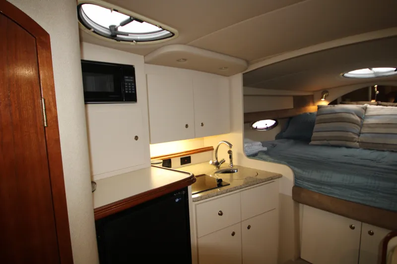 Slide: The Image of Interior of 2003 Cruisers Yachts 320 Express with kitchenette and cozy sleeping area. - 21