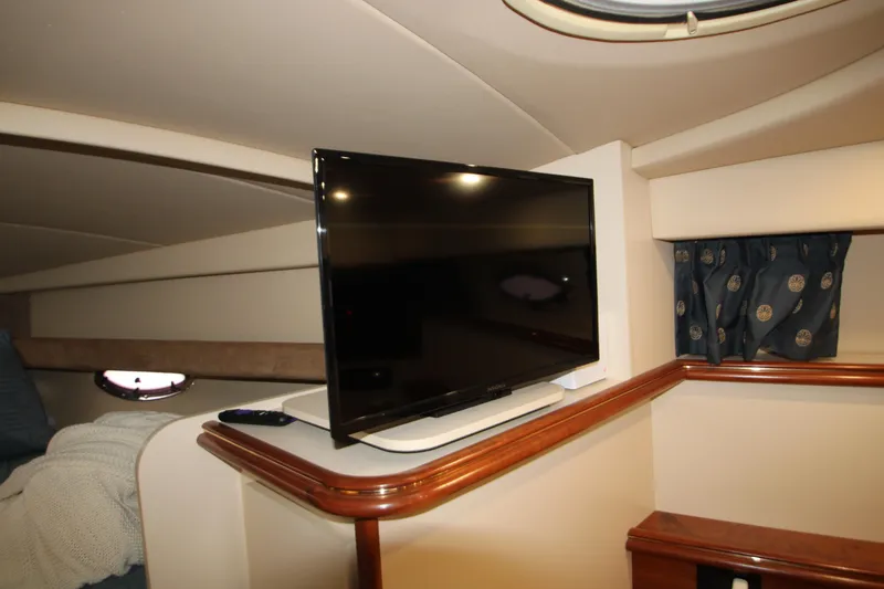 Slide: The Image of Interior of 2003 Cruisers Yachts 320 Express with mounted TV and elegant wood trim. - 26