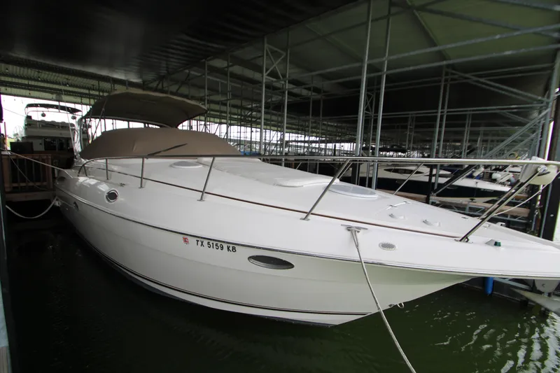 Slide: The Image of 2003 Cruisers Yachts 320 Express docked in a covered marina. - 3