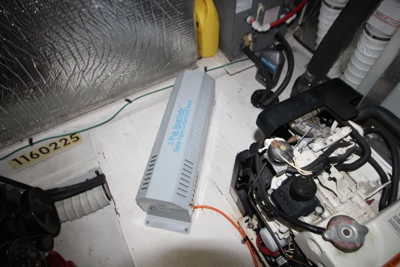 Slide: The Image of Engine compartment of a 2003 Cruisers Yachts 320 Express with mechanical components visible. - 30