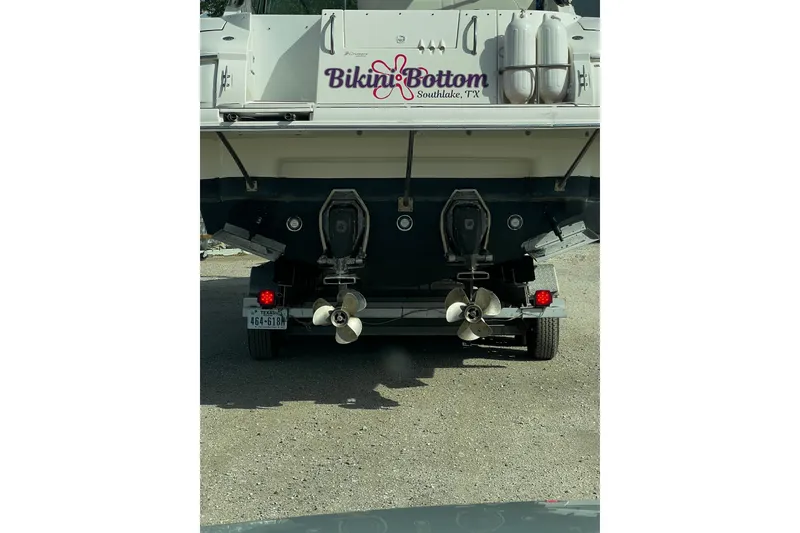 Slide: The Image of 2003 Cruisers Yachts 320 Express on trailer, featuring dual propellers and "Bikini Bottom" branding. - 31