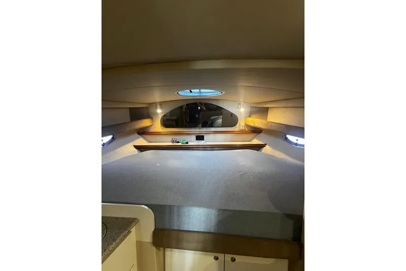 Slide: The Image of Interior cabin of 2003 Cruisers Yachts 320 Express, featuring cozy sleeping area and ambient lighting. - 33