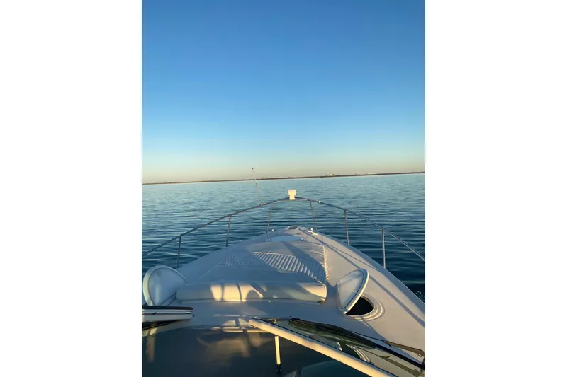 Slide: The Image of 2003 Cruisers Yachts 320 Express on calm water under clear blue sky. - 36