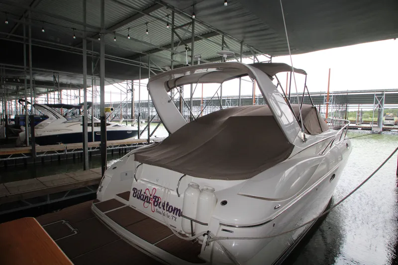 Slide: The Image of 2003 Cruisers Yachts 320 Express docked in a covered marina. - 4