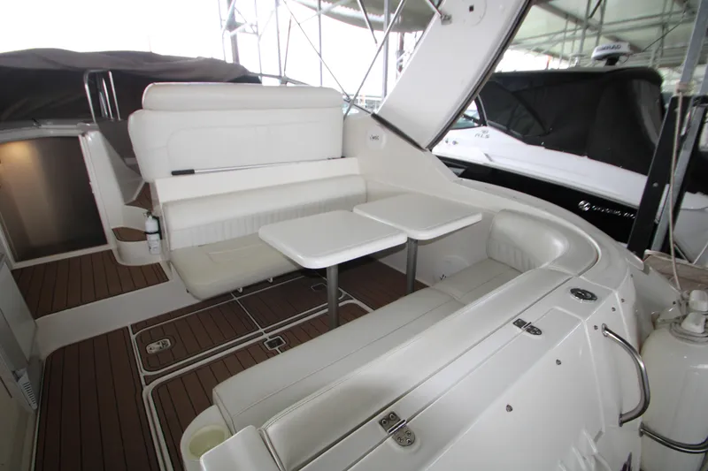 Slide: The Image of 2003 Cruisers Yachts 320 Express interior with white seating and wooden flooring. - 6
