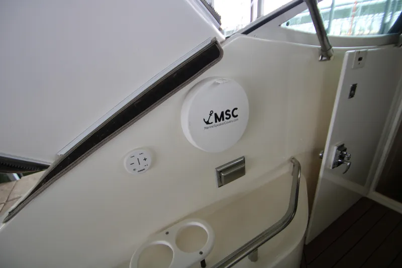 Slide: The Image of 2003 Cruisers Yachts 320 Express interior with MSC marine speaker cover and controls. - 8