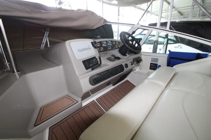 Slide: The Image of 2003 Cruisers Yachts 320 Express cockpit with Garmin navigation system and leather seating. - 9