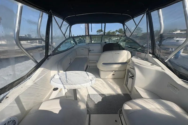 Slide: The Image of Interior of 2008 Maxum 2700 SE boat with seating and table under canopy. - 11